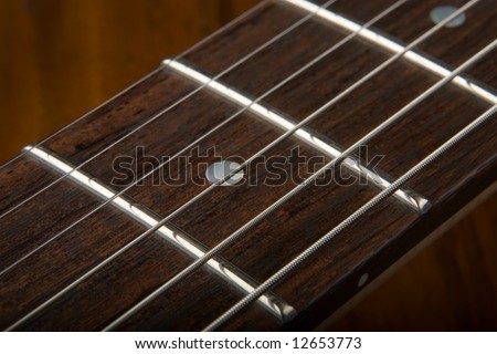 Closeup of six string guitar fret board