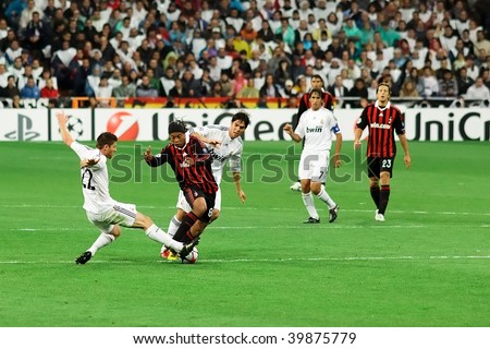 MADRID - OCT 21: AC Milan\'s Ronaldinho attempts to beat Xabi Alonso during Milan\'s 3-2 victory over Real Madrid in Champions League group stage action October 21, 2009 in Madrid, Spain.