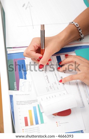 Business woman\'s hands and check book.