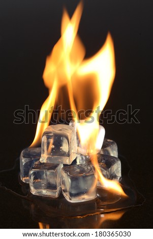 Ice cubes and fire on black background
