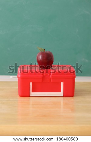 School education still life with apple on lunch box
