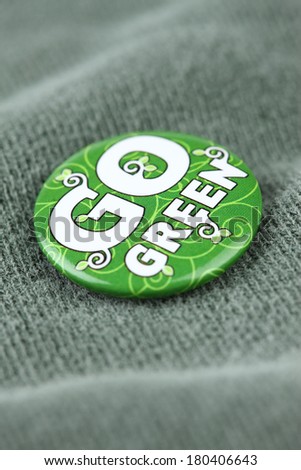 Go Green pin on shirt close up