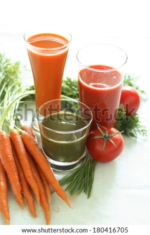 still life with carrots, carrot juice, tomatoes, and tomato juice