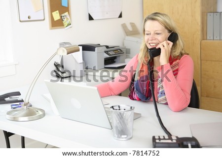 Woman in home office on phone