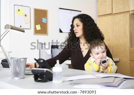 Woman working in home office with baby