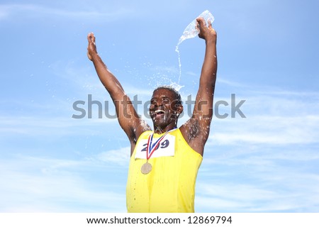 Athlete with medal celebrating and pouring water on head