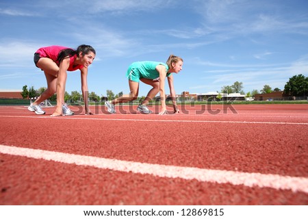 Two women on track in starting positions