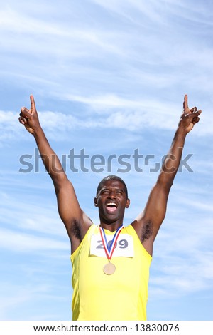 Track athlete with medal celebrating