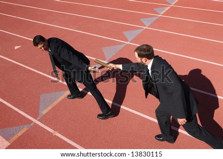stock photo : Businessmen passing the baton in a track relay