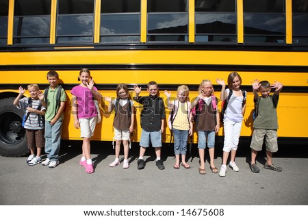 Elementary school students lined up by bus