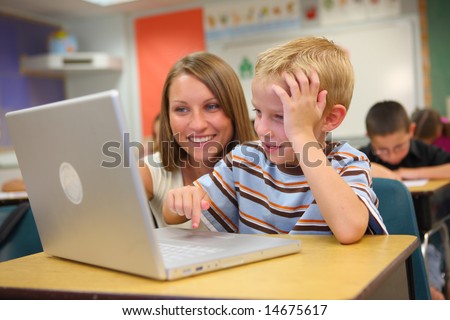 Elementary school student and teacher with laptop