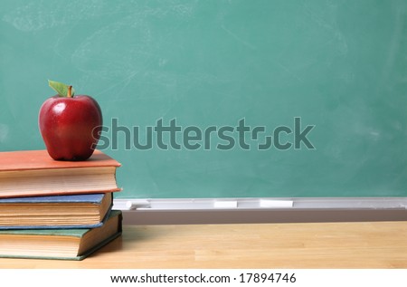 Apple on School Books with copy space on chalk board