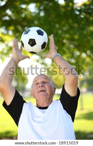 Senior man catching ball