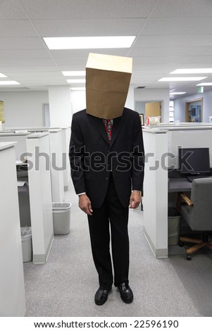 Businessman in office with bag on head