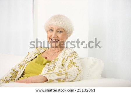 Portrait of senior woman sitting on couch