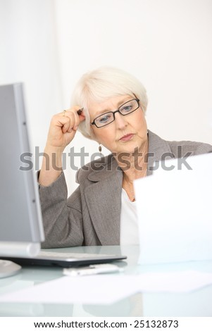 Professional senior businesswoman looking at papers