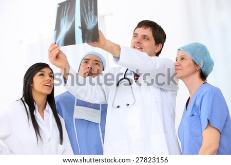 Group of medical personnel looking at x-ray
