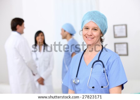 Portrait of nurse with other medical personnel in background