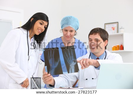 Medical personnel looking at x-ray