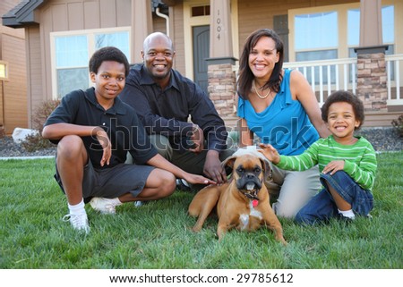 Family with dog in grass by home
