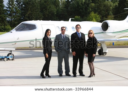 Group of business people with corporate jet in background