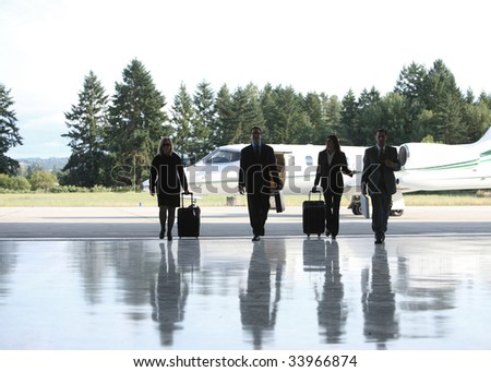 Group of businesspeople walking to corporate jet