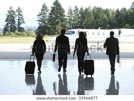 Group of businesspeople walking to corporate jet