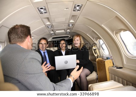 Group of businesspeople meeting in private jet