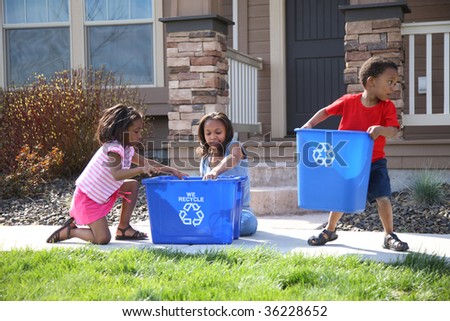 Three children putting items into recycle bin