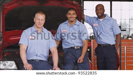 Portrait of three auto shop mechanics