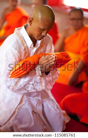 BANGKOK,THAILAND JULY 14 :  Newly ordained Buddhist monk pray with priest procession .Newly ordained Buddhist monks have a ritual in the temple procession in Bangkok Thailand on July 14, 2012