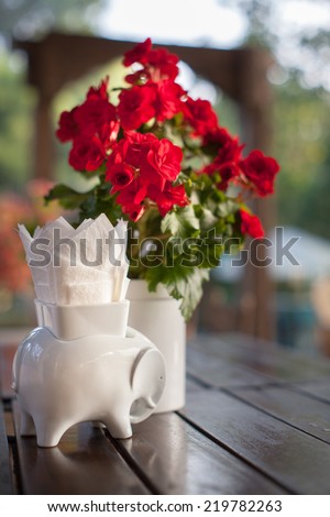 Ceramic tableware on the wooden, Paper tissue box and flower vase