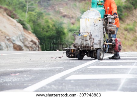 Thermoplastic spray marking machine during road construction works