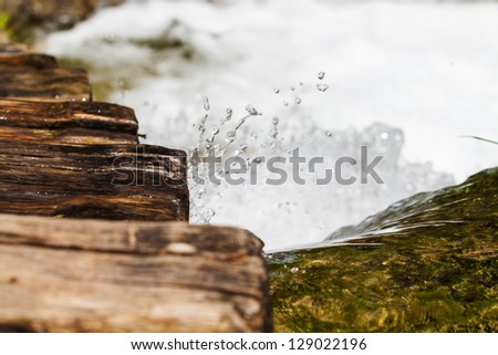 Wet wooden stairs with whitewater splash