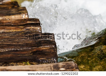 Wet wooden stairs with whitewater