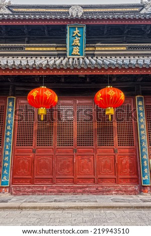 Red Chinese paper lanterns and wooden doors in front of Jiangyin Temple in China