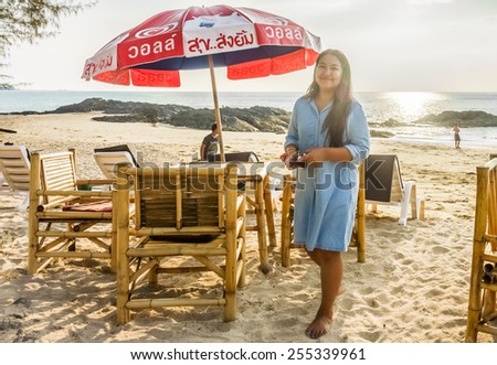 PHANG NGA, THAILAND - APRIL 20, 2014: The Wall\'s logo on beach umbrella at Pak Weep beach, Khao Lak. Wall\'s is an ice cream brand owned by the Anglo-Dutch food and personal care conglomerate Unilever.