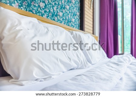 Bed, pillows and bedsheets in the bed room of hotel resort for Hospitality industry