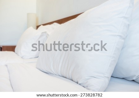 Bed, pillows, bedsheets and lamp in the hotel resort room for Hospitality industry