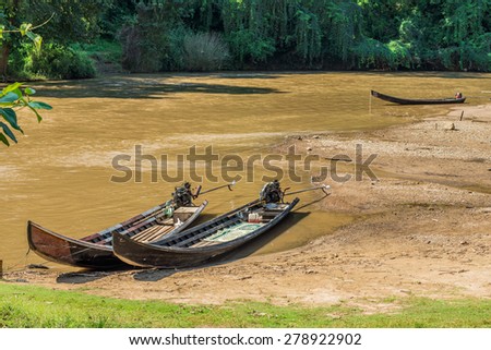 Long tail wooden motorboats in river are vintage water transportation in Thailand