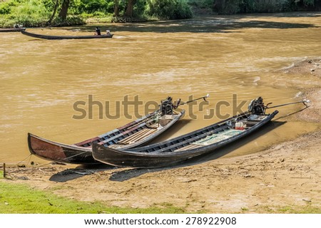 Long tail wooden motorboats in river are vintage water transportation in Thailand