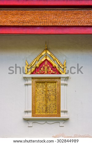 The religion art of wooden window with red roof in Thailand Buddhist temple