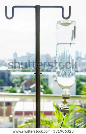 Intravenous bag on a pole. It is connected to Intravenous lines.