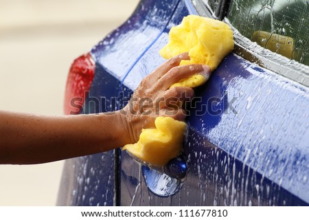 outdoor car wash with yellow sponge