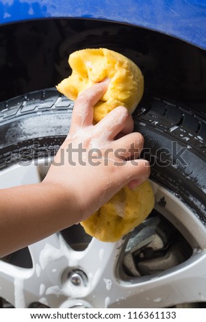 Outdoor tire car wash with yellow sponge