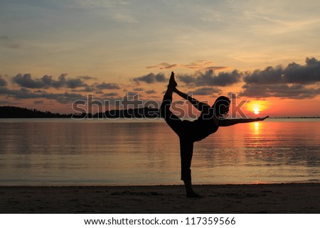 Silhouette of a beautiful yoga girl at sunrise on the beach,Natarajasana,Lord of the Dance Pose