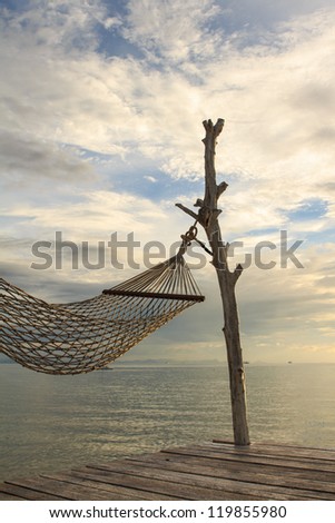 white hammock on terrace at dusk over ocean