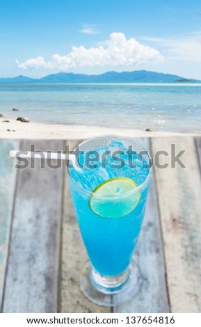 Blue  cocktail on grunge table facing blue sea