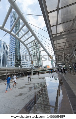 BANGKOK -JULY 7: View of high buildings and public sky walk for transit between Sky Transit and Bus Rapid Transit Systems at Sathorn-Narathiwas junction on July 7, 2013 in Bangkok, Thailand.