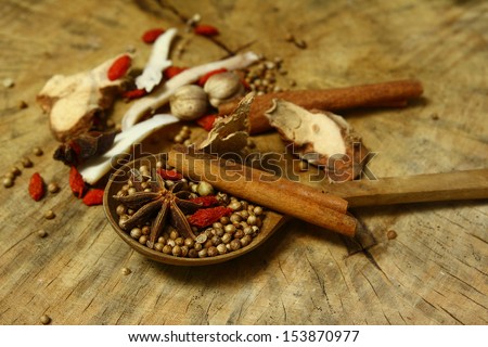 Herbs and spicies aromatic ingredients  natural food additives on grunge wooden board